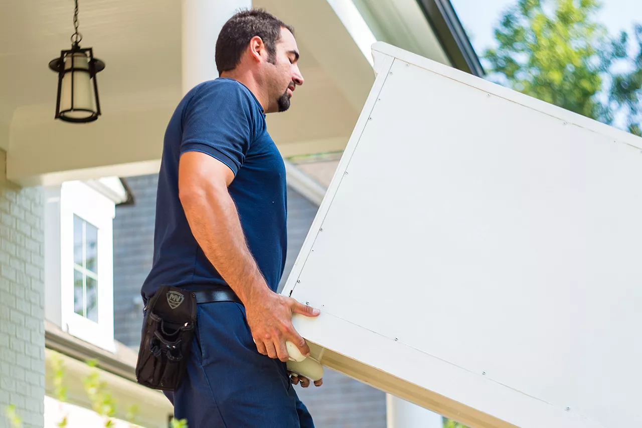 Image of a Havertys delivery man carrying furniture into a customer's home