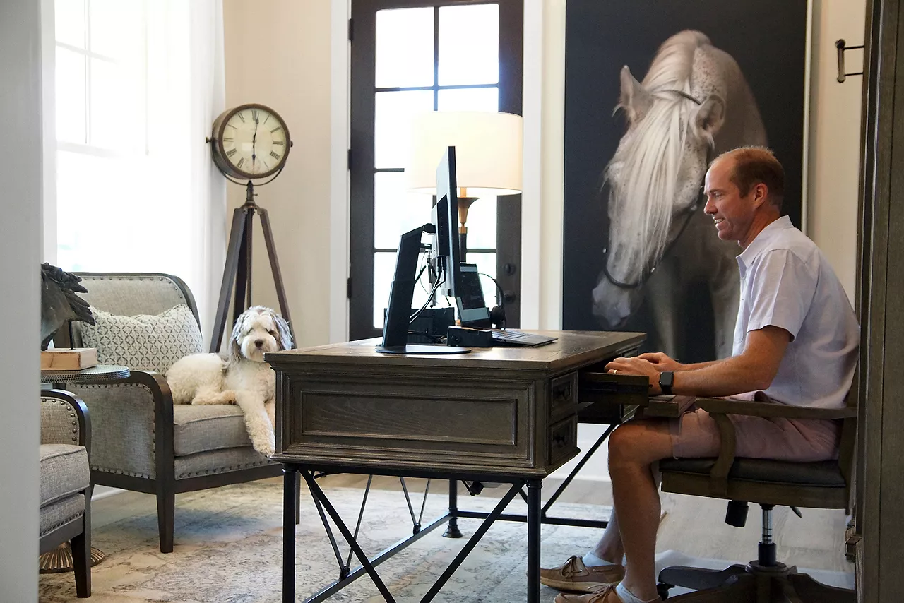 Shot of man working in an office with his dog