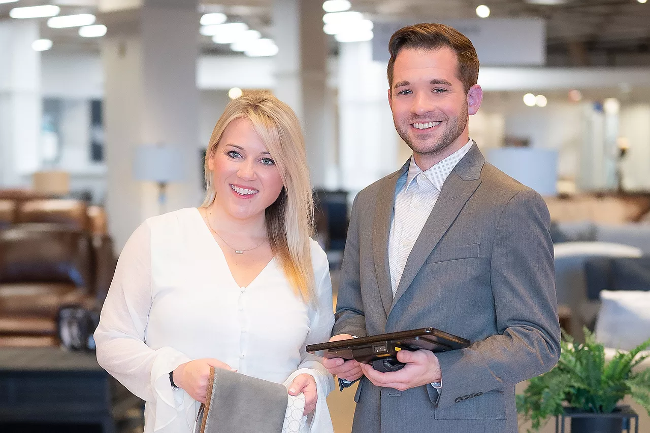 Image of two Havertys designers smiling and holding fabric swatches