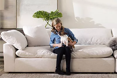 Happy customer sitting on sofa with puppy