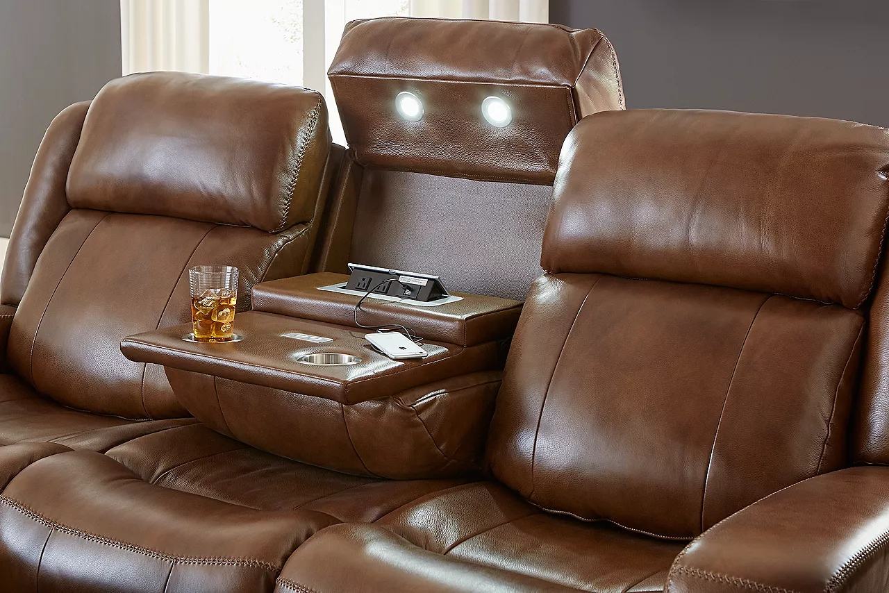 Aviator sofa in Caramel. Closeup showing the cupholders and controls inside the center console seat.