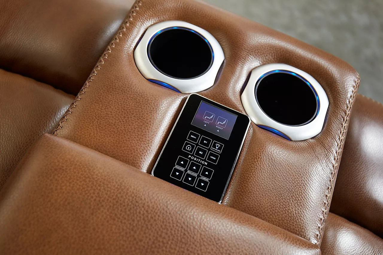Aviator Loveseat in Caramel. Closeup showing the cupholders and controls in the center console.