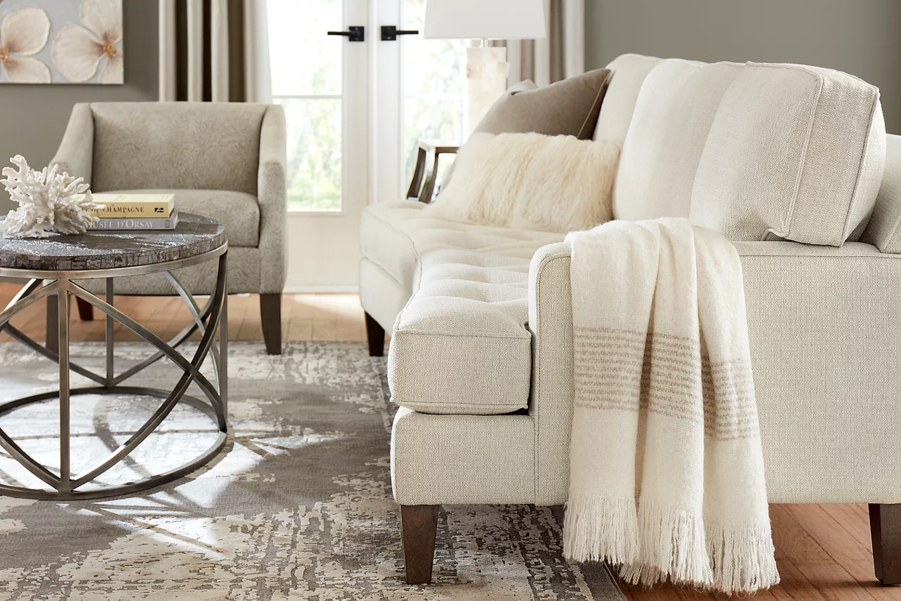 Gianna Conversation Sofa in Bermuda Natural and a Gianna Chair in Tangle Linen in a room scene.