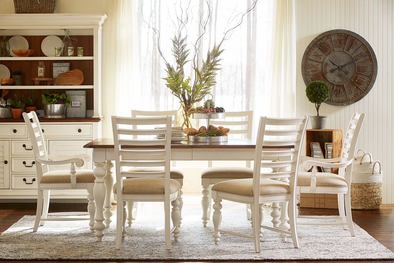 Newport Dining Table, Dining Chairs, Armchairs, and China Cabinet in Distressed White in a room scene.