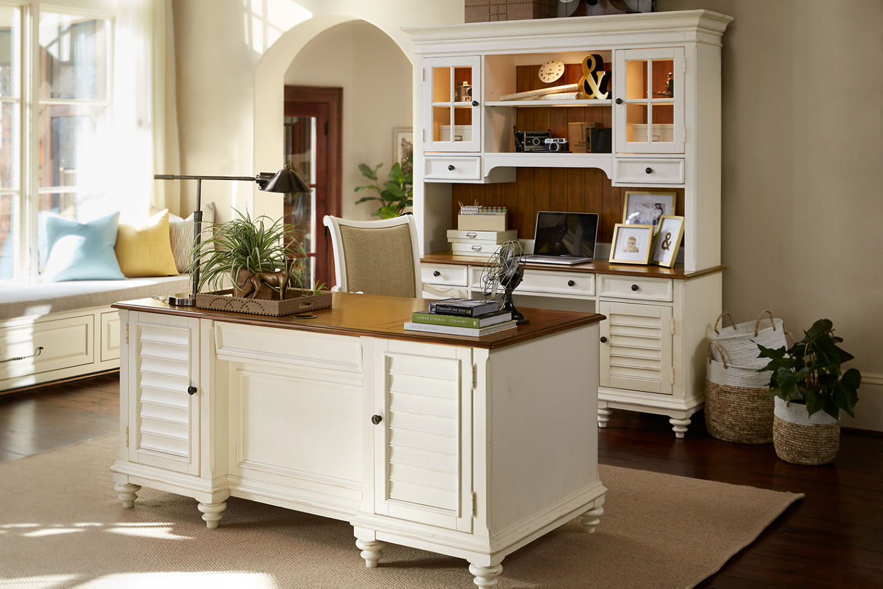 Newport executive desk, office chair, and desk with hutch in a room scene.
