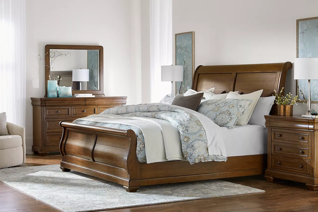 Westhaven sleigh bed, dresser with mirror and bachelor chest in a room scene