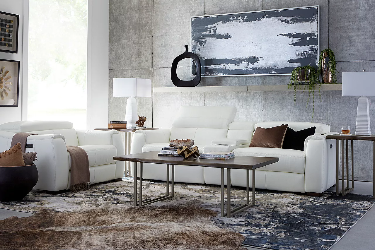 Leo Sofa and Recliner in Optical White. One of the headrests of the sofa is pulled up in a room scene.