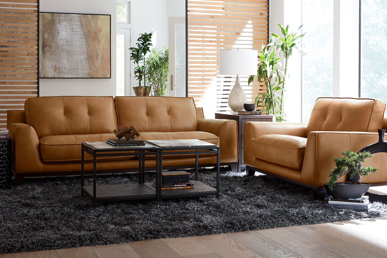 Phoenix sofa and chair and a half in Caramel and two Keaton Vellum Top Bunching tables and a chairside table in a room scene 