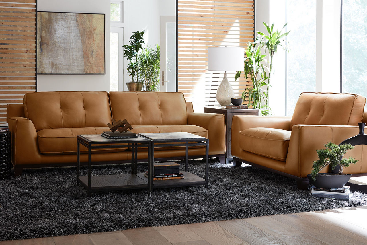 Phoenix sofa and chair and a half in Caramel and two Keaton Vellum Top Bunching tables and a chairside table in a room scene 