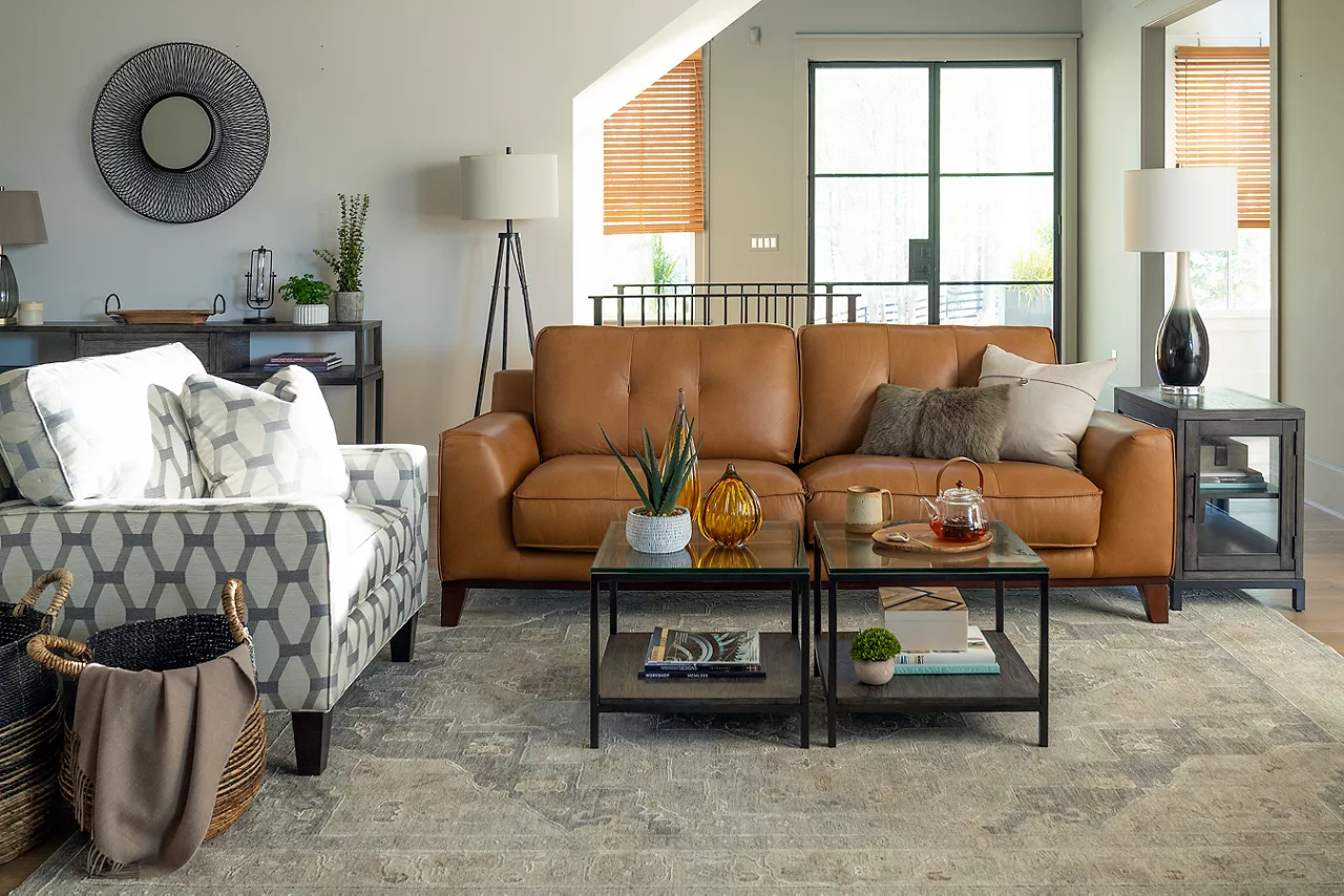 A Phoenix sofa in Caramel and a Katherine matching chair in custom fabric and two Keaton Vellum Top Bunching tables  and  a chairside table in a room scene 