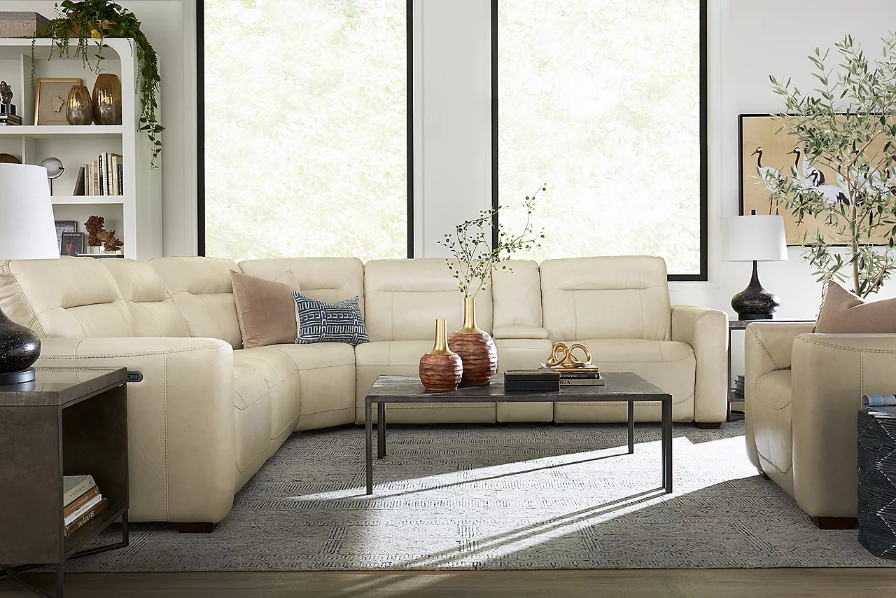Melbourne Sectional and Recliner in Ice and Kori Bunching Coffee Table in Pine and Cork in a room scene.