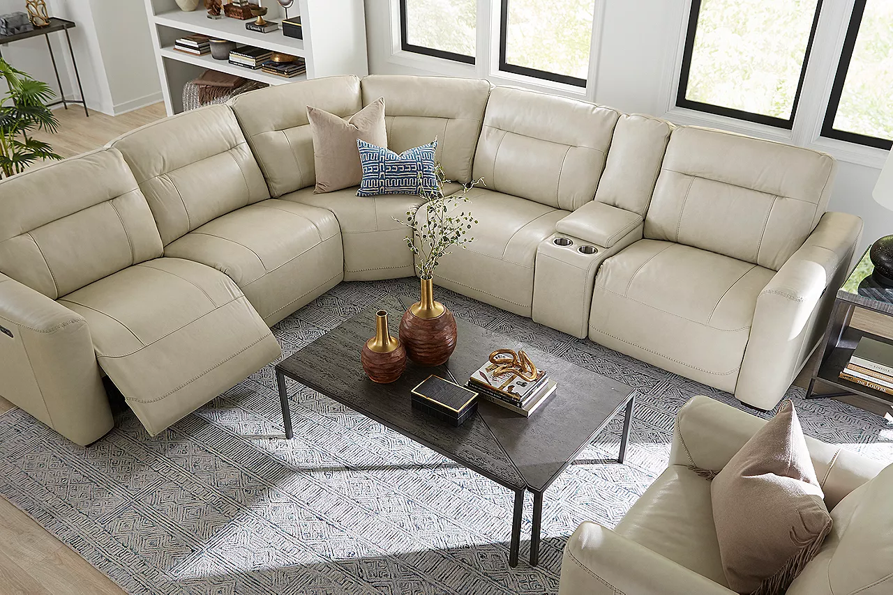 Overhead view Melbourne Sectional with one side reclined and Recliner in Ice and Kori Bunching Coffee Table in Pine and Cork in a 