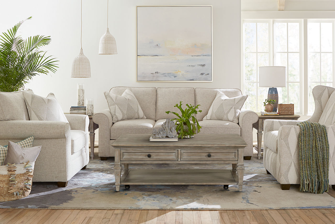  Sandy Sofa, Accent Chair and Chair in Linen and Berkley Coffee Table and End Tables in Dovetail Grey in a room scene.