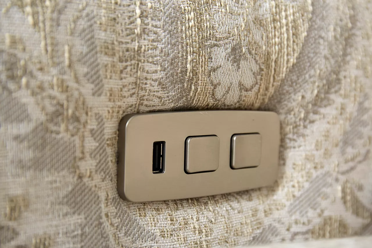 Ava Accent Recliner in Manchester Mineral. Closeup of the arm showing the adjustment buttons and the USB port.