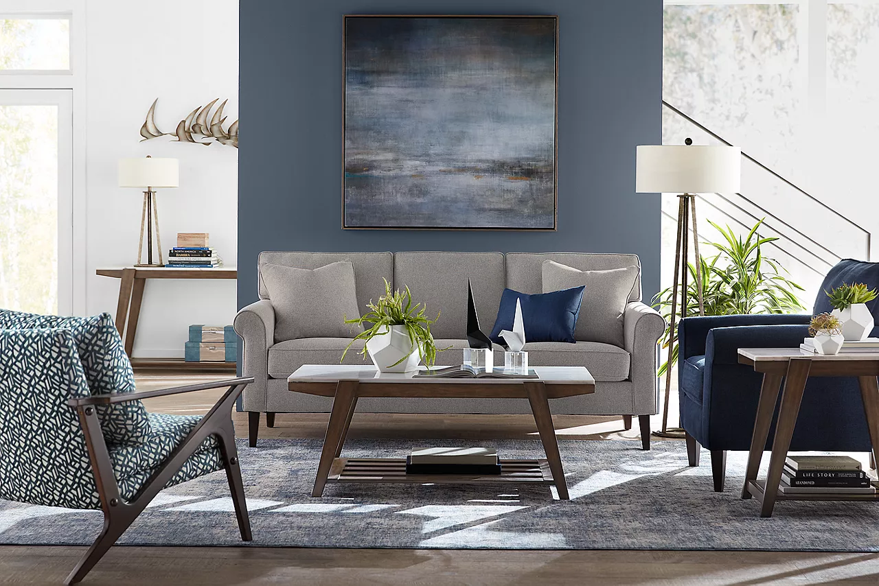 Jenna Sofa in Platnum, Jenna Chair in Navy, and Jenna Wood Accent Chair in Hamilton Drive Ink with Emory coffee, sofa and end tables in a room scene.