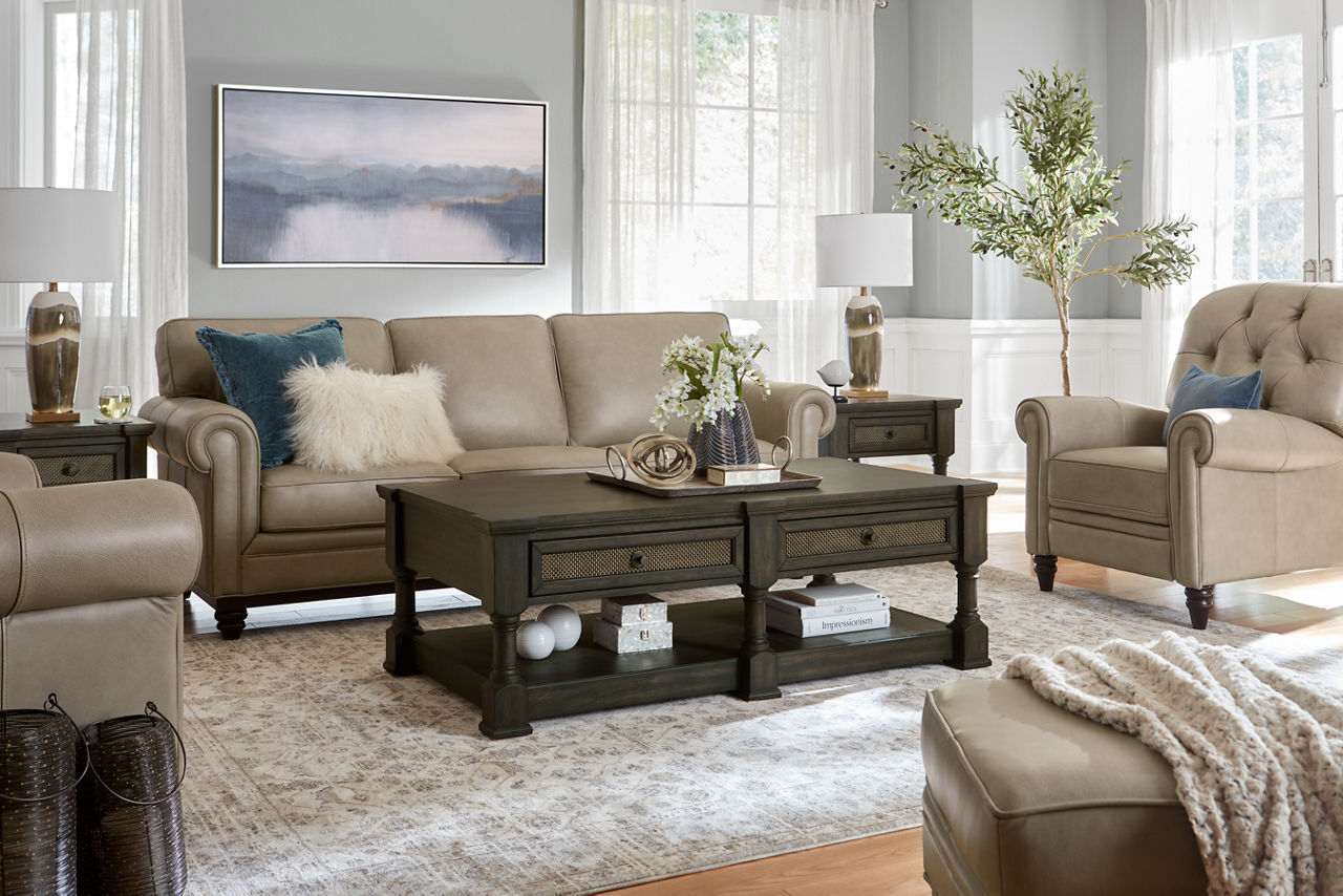A Hartford Sofa, Chair, Recliner, and ottoman in Pebble and an Aberdeen rectangular coffee and end table in a room scene.