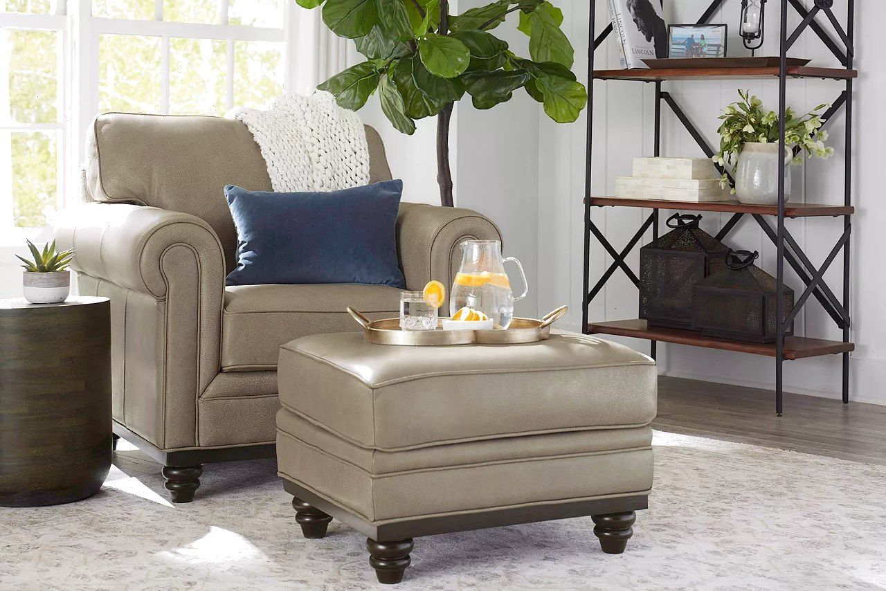 A Hartford chair and ottoman in Pebble in a room scene.