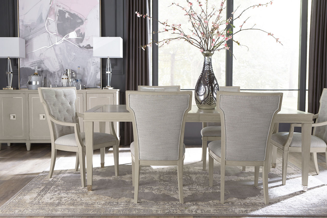 Hyde Park Dining Table, Dining Side Chairs, Armchairs, and Buffet in Heather Grey in a room scene.