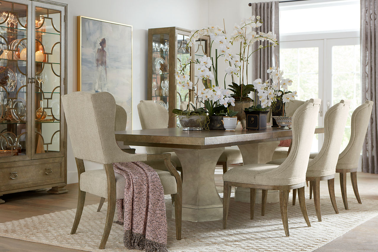 Westcliffe Dining Table, Dining Chairs, Host Armchairs, and Display Cabinets in Burnished Bark in a room scene.