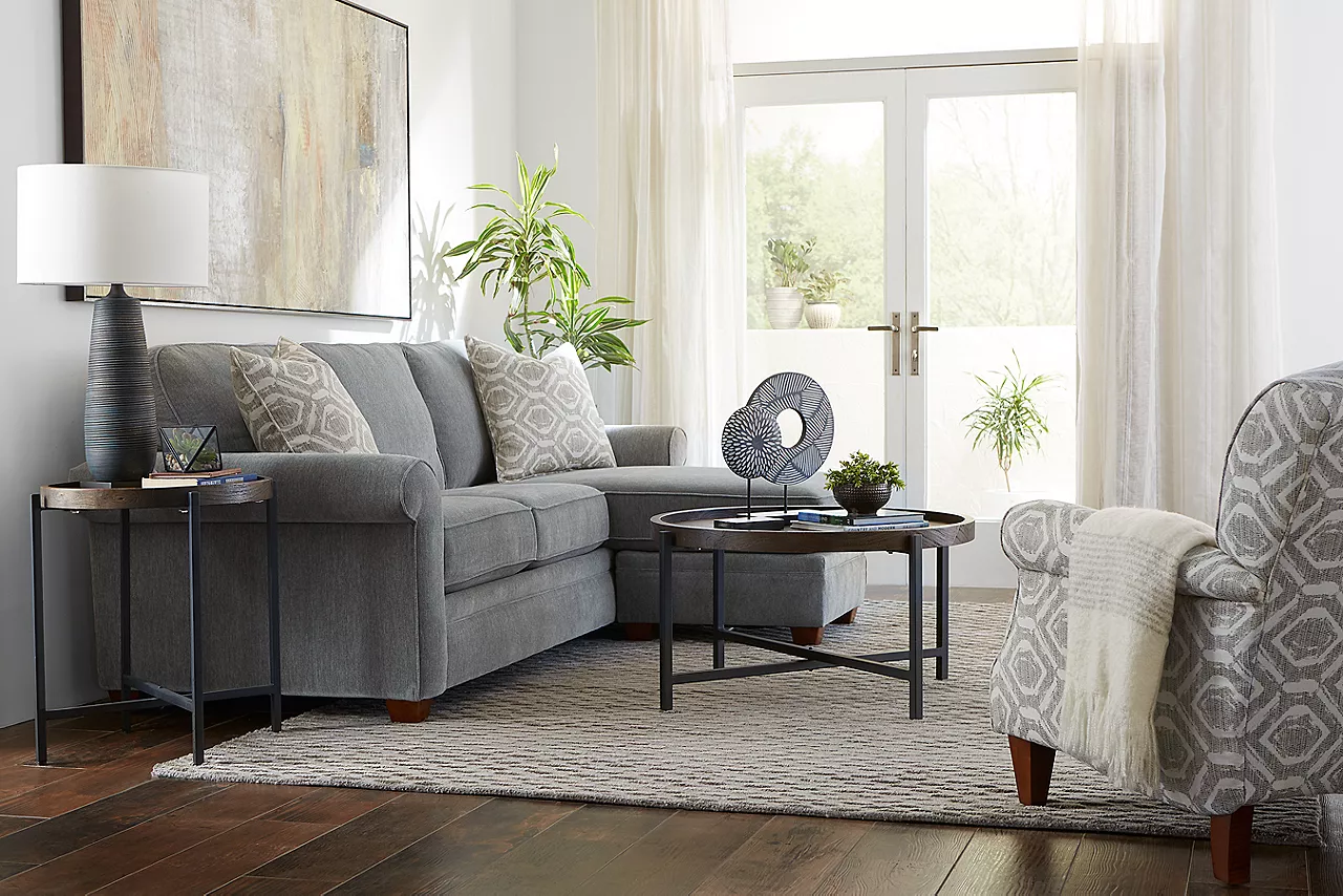  Kara Chofa in Pewter and Accent Chair in Silver with Knox coffee and end tables in a room scene.