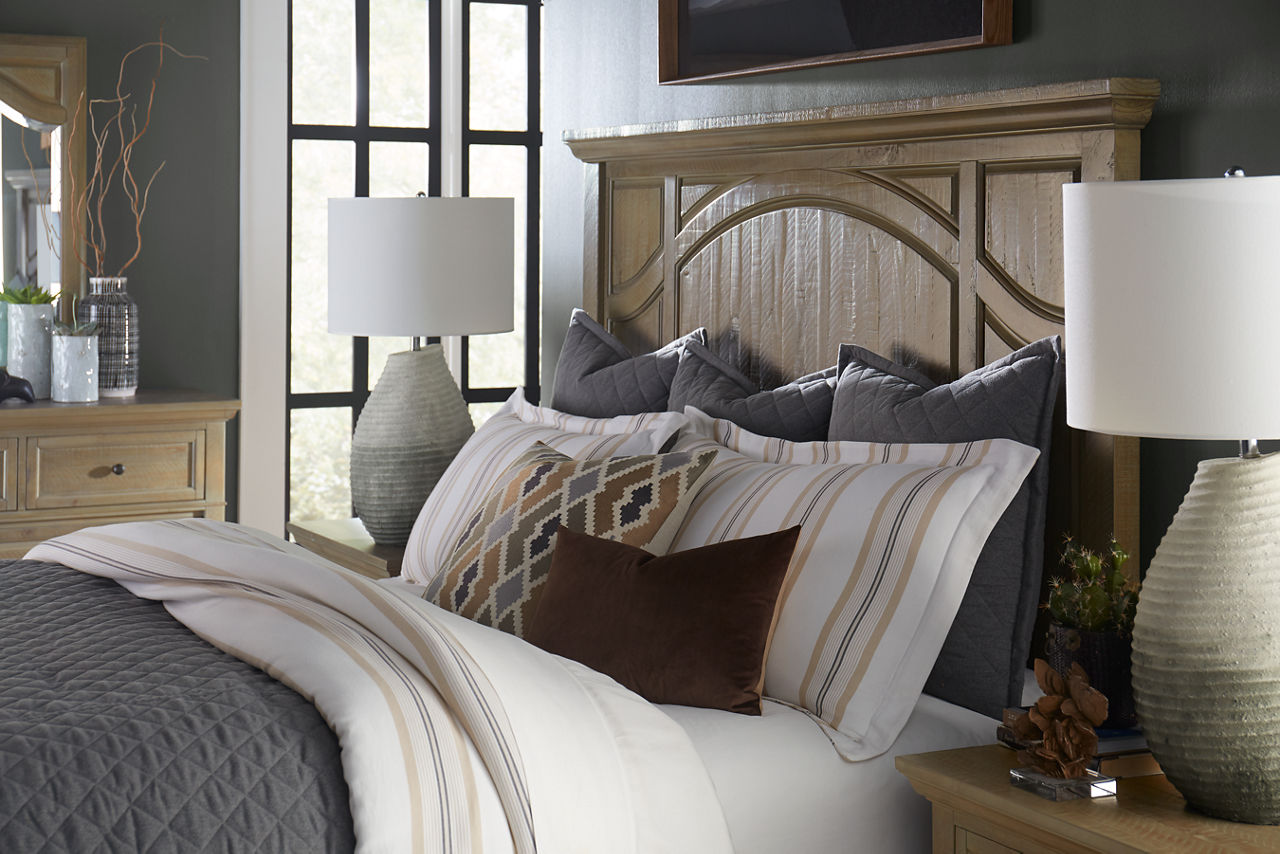 The Blue Ridge bed, drawer nightstand, and dresser with mirror in Dovetail Grey in a room scene.