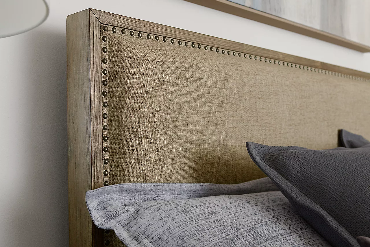Boulder Creek upholstered headboard showing texture of fabric and nail head details in a room scene.