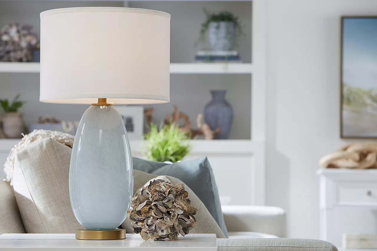 Destinations 3-Seat Sofa in Convert Ivory and a Hannah Table Lamp in a room scene.