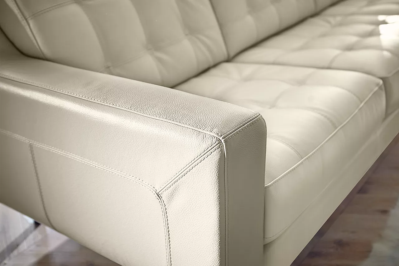 Closeup to show the details of the side of a Metropolis Sofa in Pearl in a room scene.