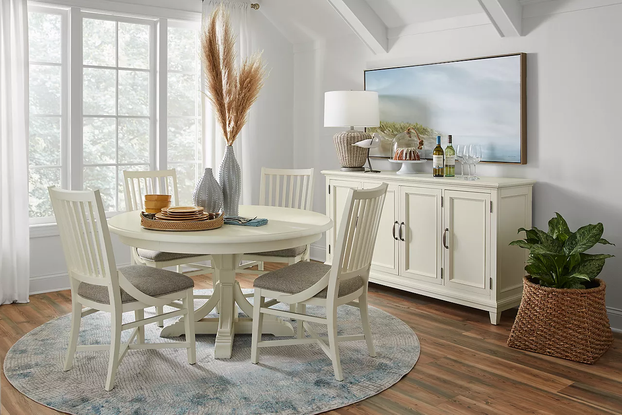 Sheffield Round Table, Upholstered Chairs, and Buffet in White in a room scene.