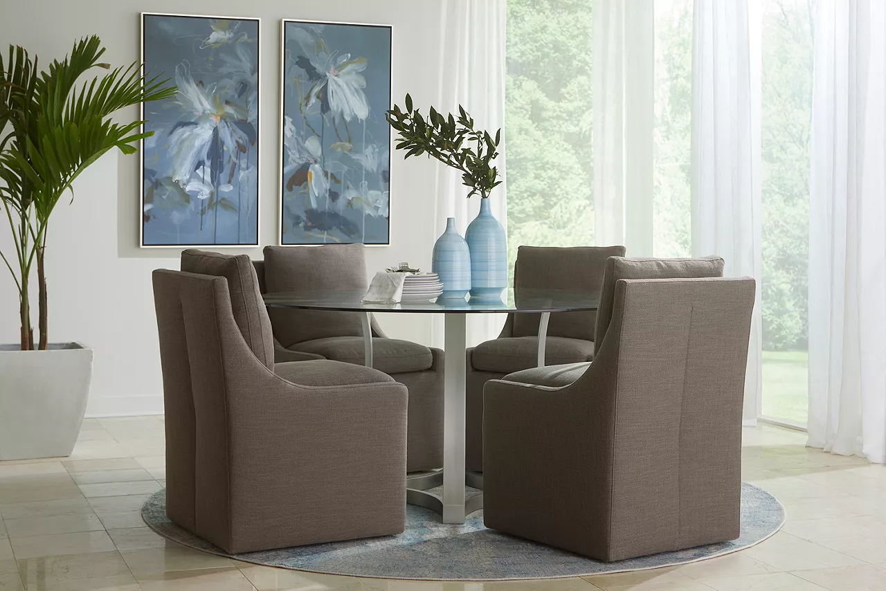 Curved Base Landry dining table with Nolan dining chair in Smoke in a room scene