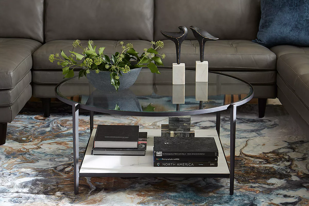 Image of a glass coffee table with two bird sculptures on top