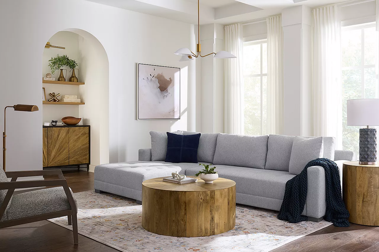 Banks Sectional in Stone, accent chair in Denim with the Cyrus occasional table collection