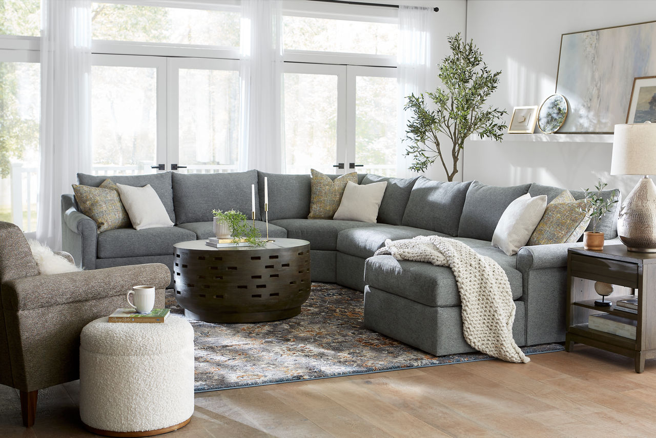Alaina Sectional room scene with Accent chair and Roscoe occasional tables 