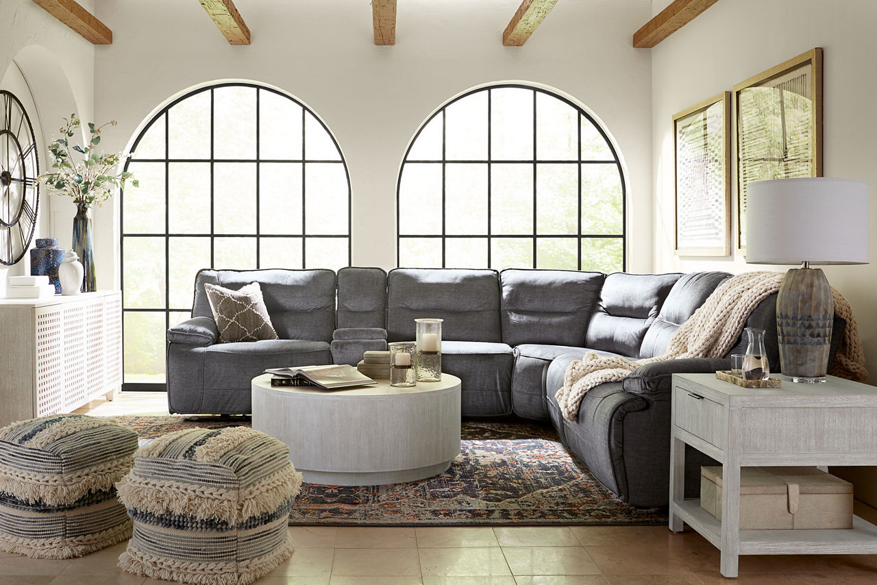  Reynolds Sectional in Granada Charcoal Ginny Coffee Table and End Table in Whitewashed in a room scene.