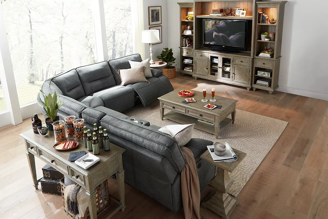 Reynolds Sectional in Granada Charcoal Berkley Entertainment Wall, Coffee Table and Sofa Table in Dovetail Grey in a Football season room scene.
