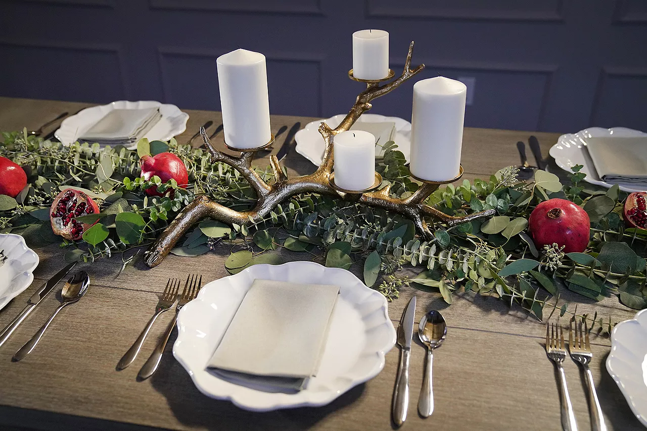 Overhead shot of tablescape featuring greenery and candles