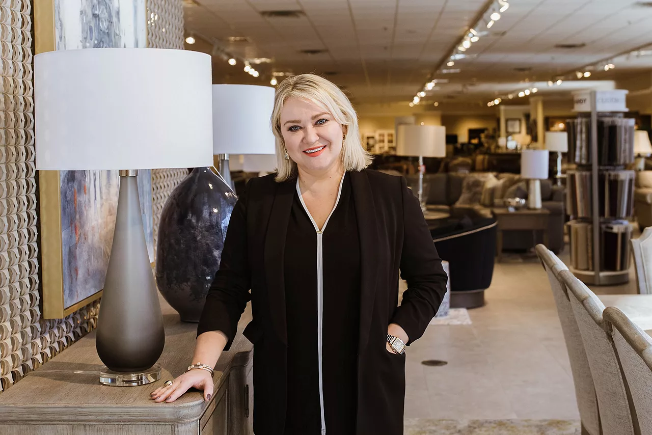 Image of a Havertys sales consultant standing by furniture and smiling