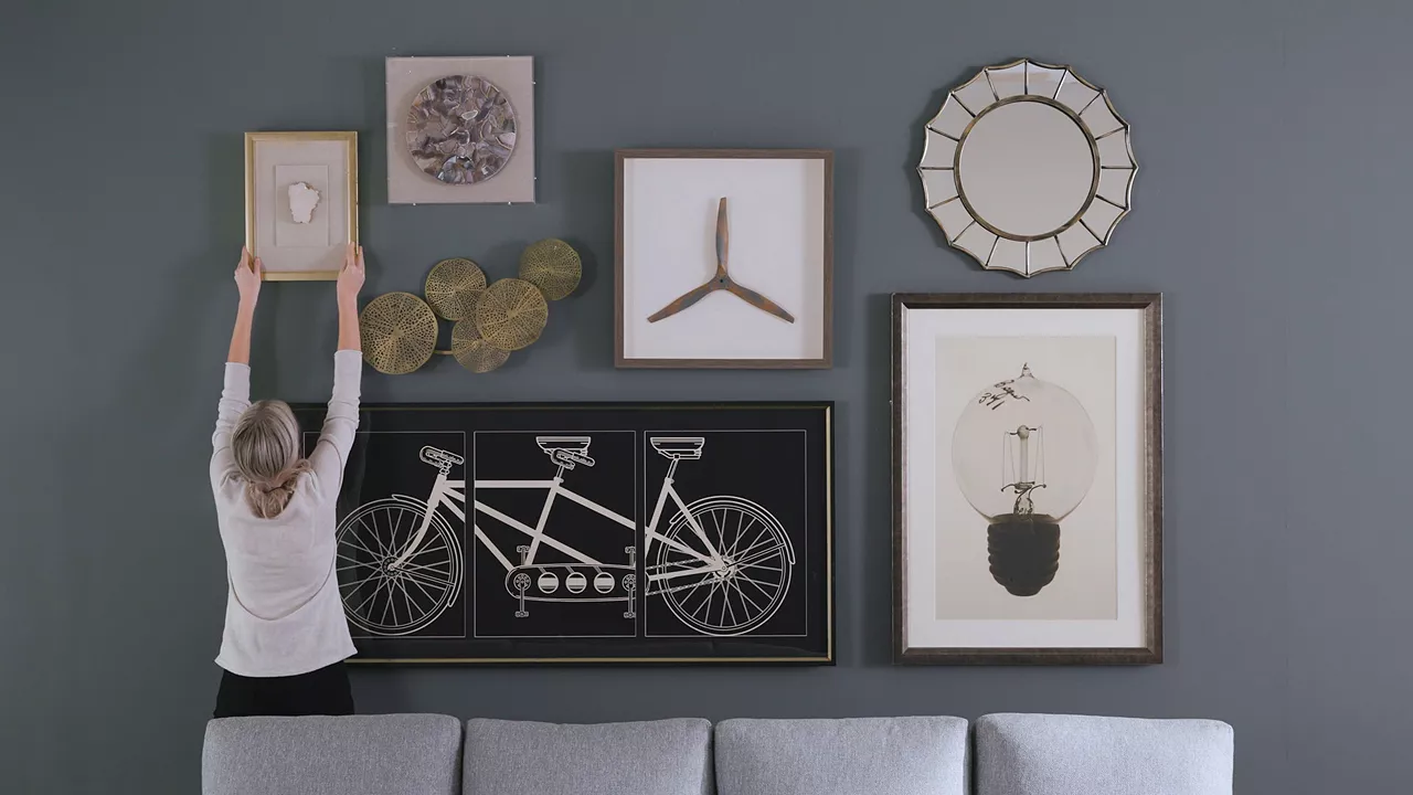 Image of woman hanging her wall art